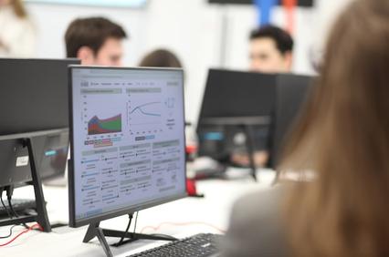 A close-up view of a computer screen displaying data visualizations in an office setting.