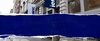 A street view showcasing a building facade with a blue and white sign that reads 'iemNYC'.