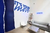 A modern lounge area featuring a blue and white mural with the phrase 'IT'S YOUR MOVE'.